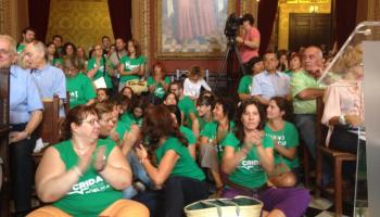 Camisetes verdes assegudes enmig de la sala defensant una educació pública de qualitat i en català.