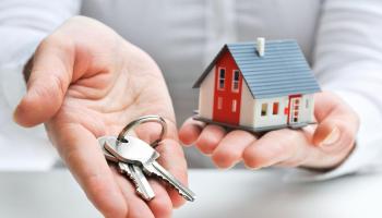 Real estate agent with house model and keys